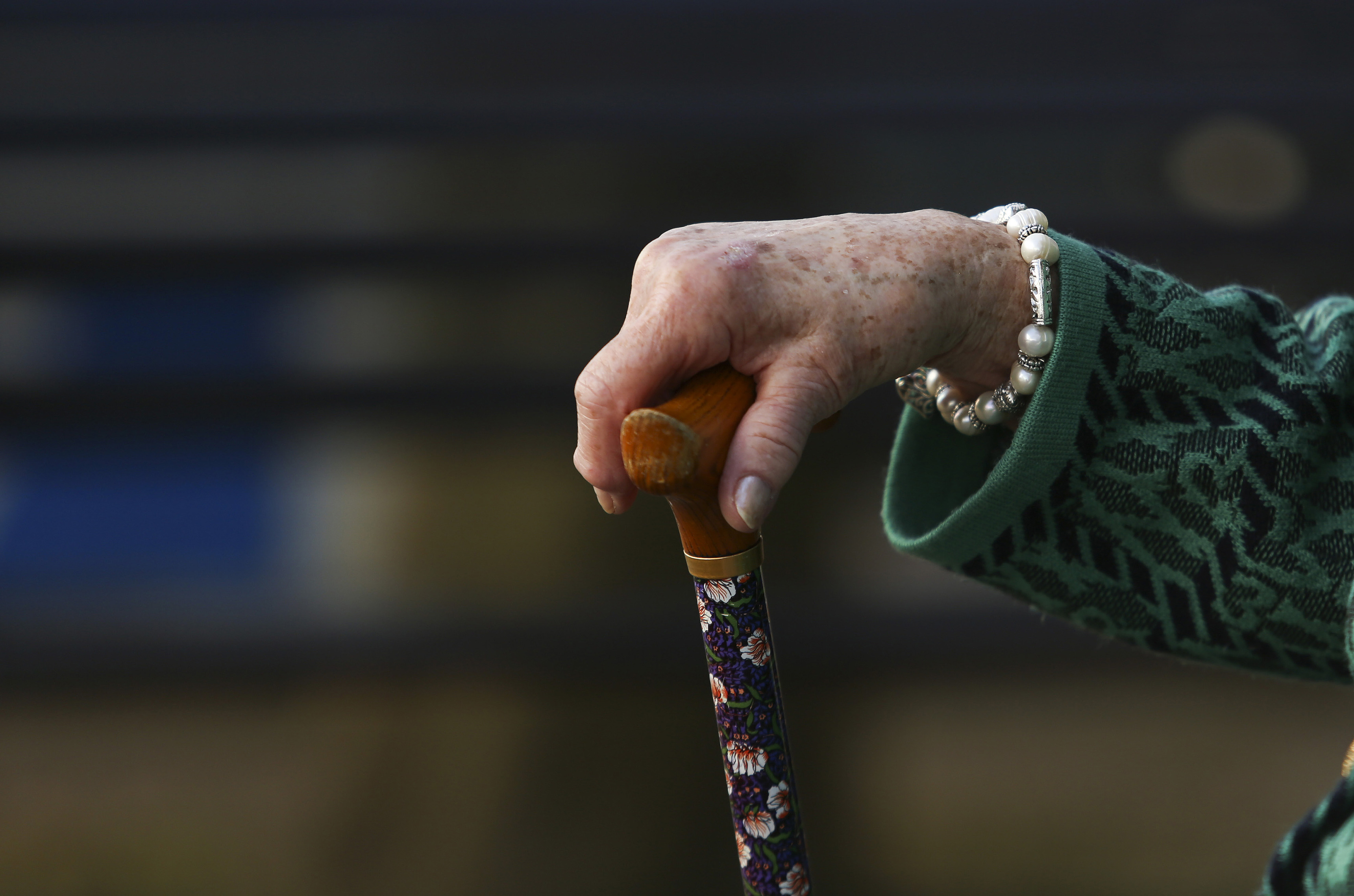 Eldlery woman holding cane Bloomberg News image