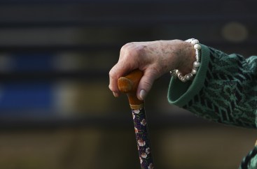 Eldlery woman holding cane Bloomberg News image