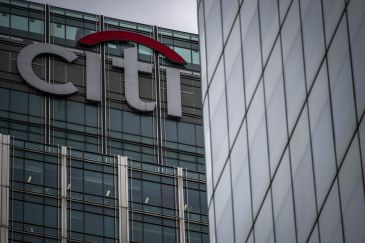 A sign sits on top of the skyscraper housing the Citigroup Inc. offices at 25 Canada Square in the Canary Wharf business, financial and shopping district in London, U.K.