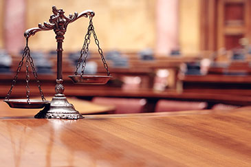 The Scales of Justice on a desk.