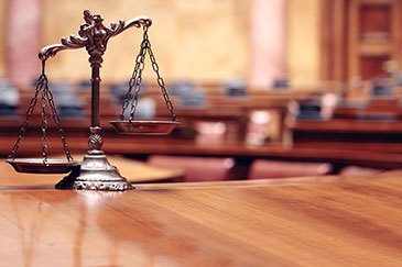 The Scales of Justice on a desk.