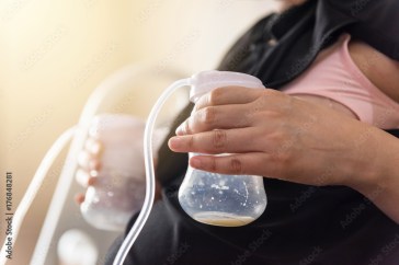 Woman pumping breastmilk