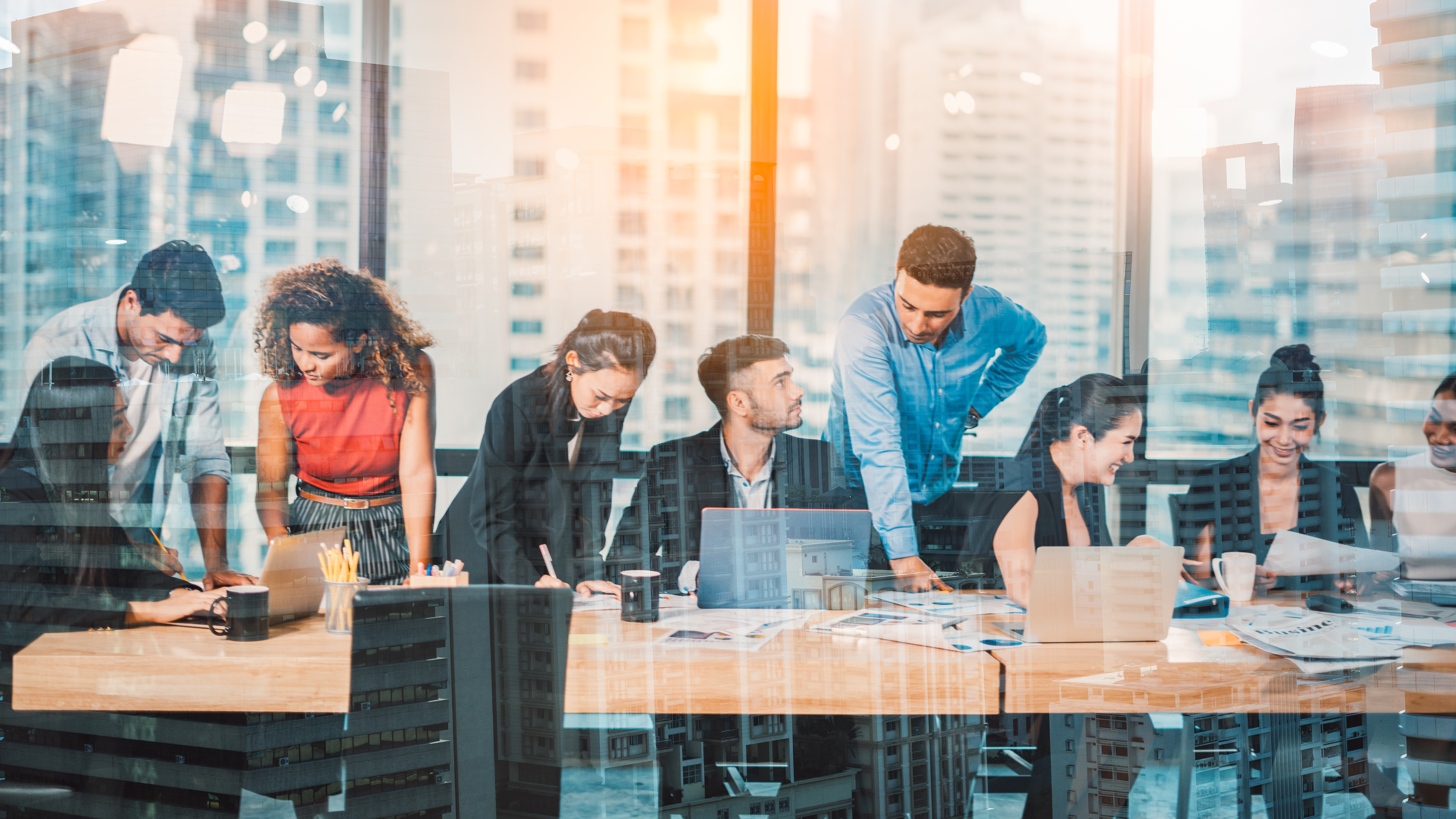 A diverse group of coworkers collaborate at a conference table