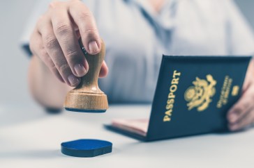 Border control officer stamps U.S. passport.