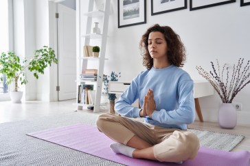 Woman meditating on a yoga mat