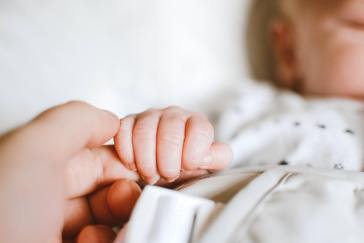 Baby holding finger