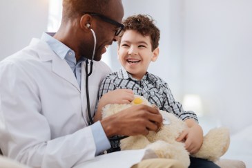 A doctor cares for a child patient.
