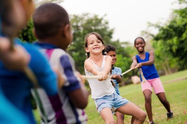 Girl playing tug of war at summer camp