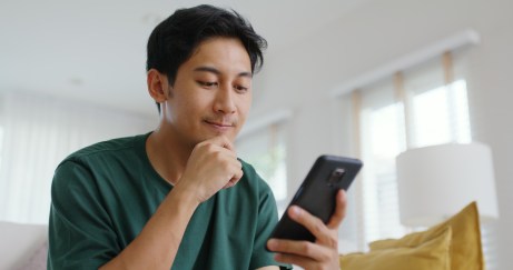 Man looking down at his smart phone