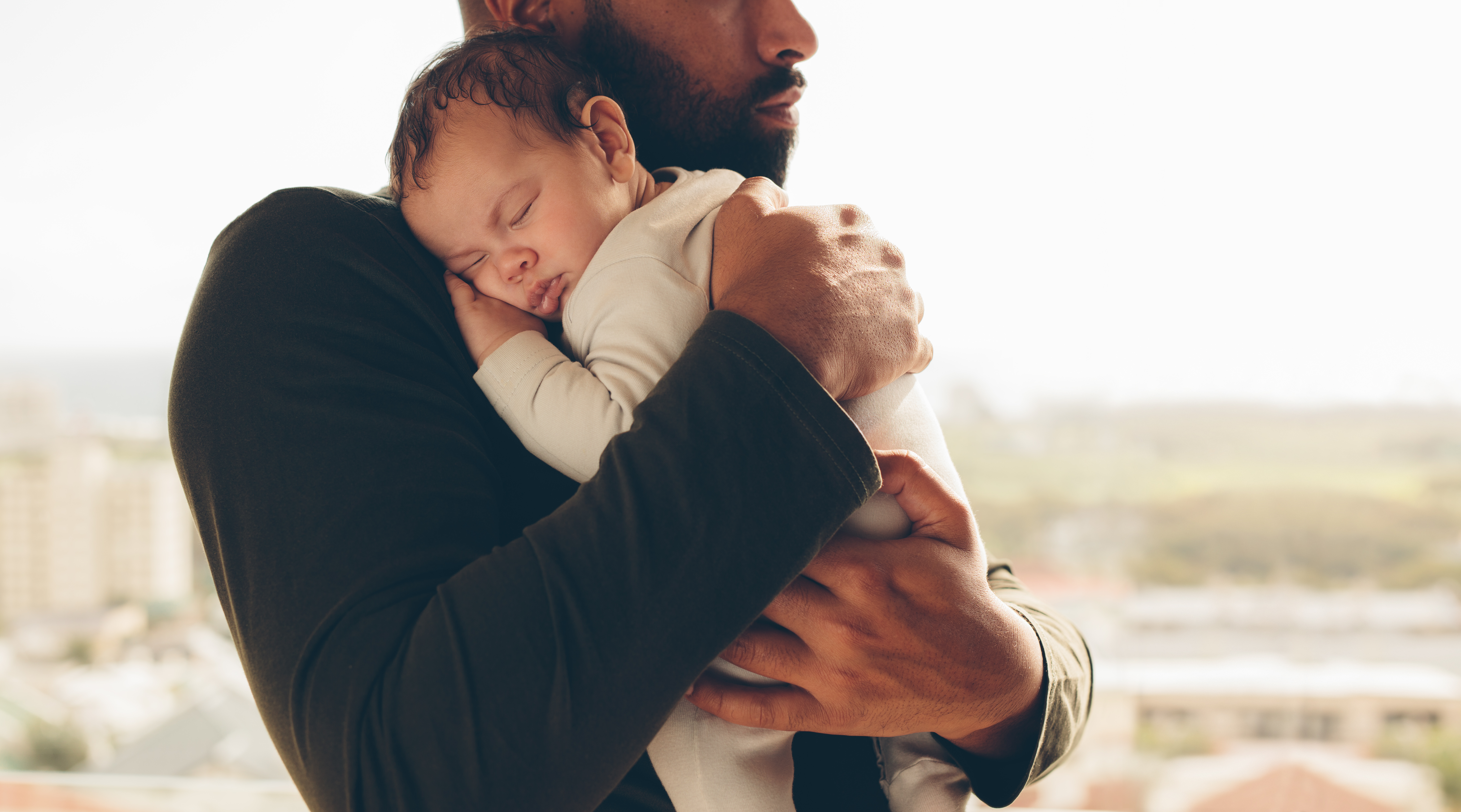 Dad holds his newborn baby.