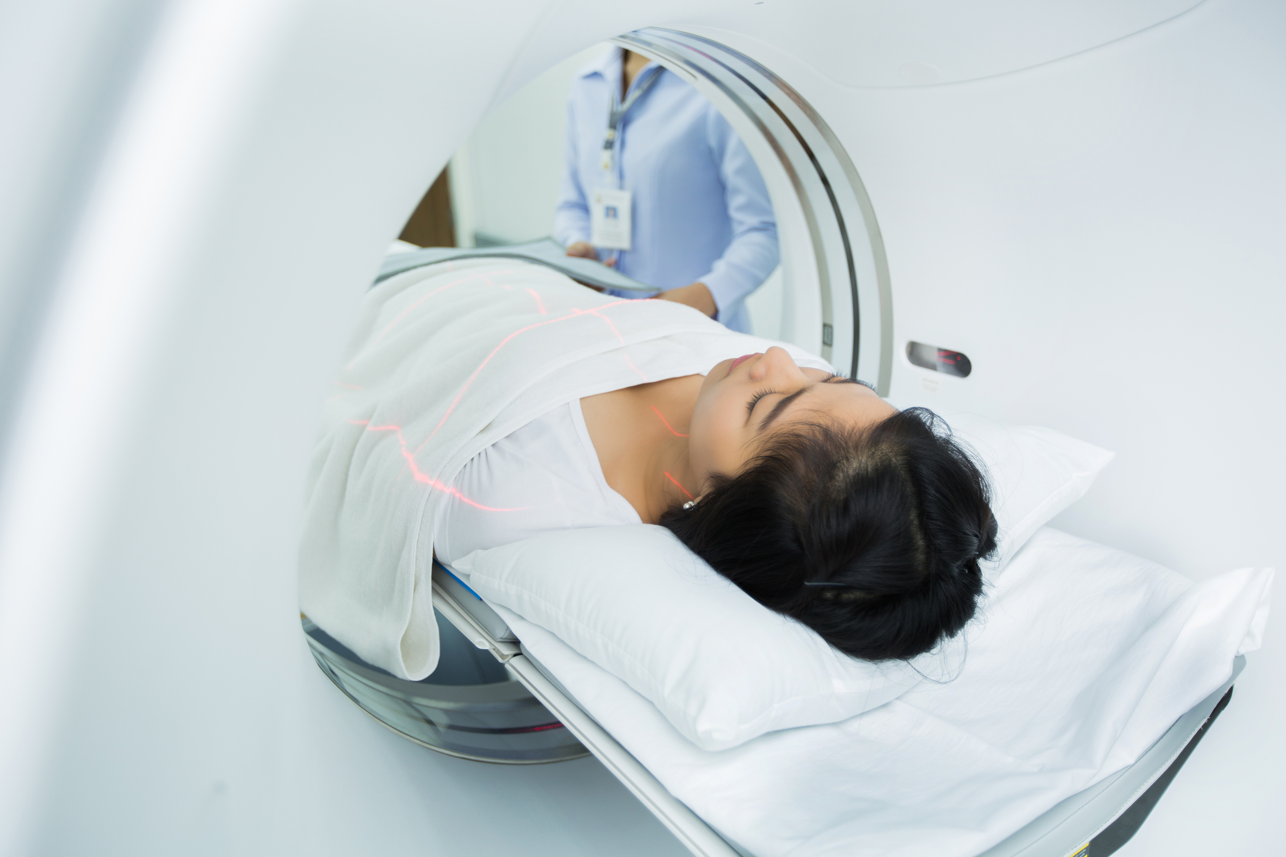 A woman is getting a CT scan.