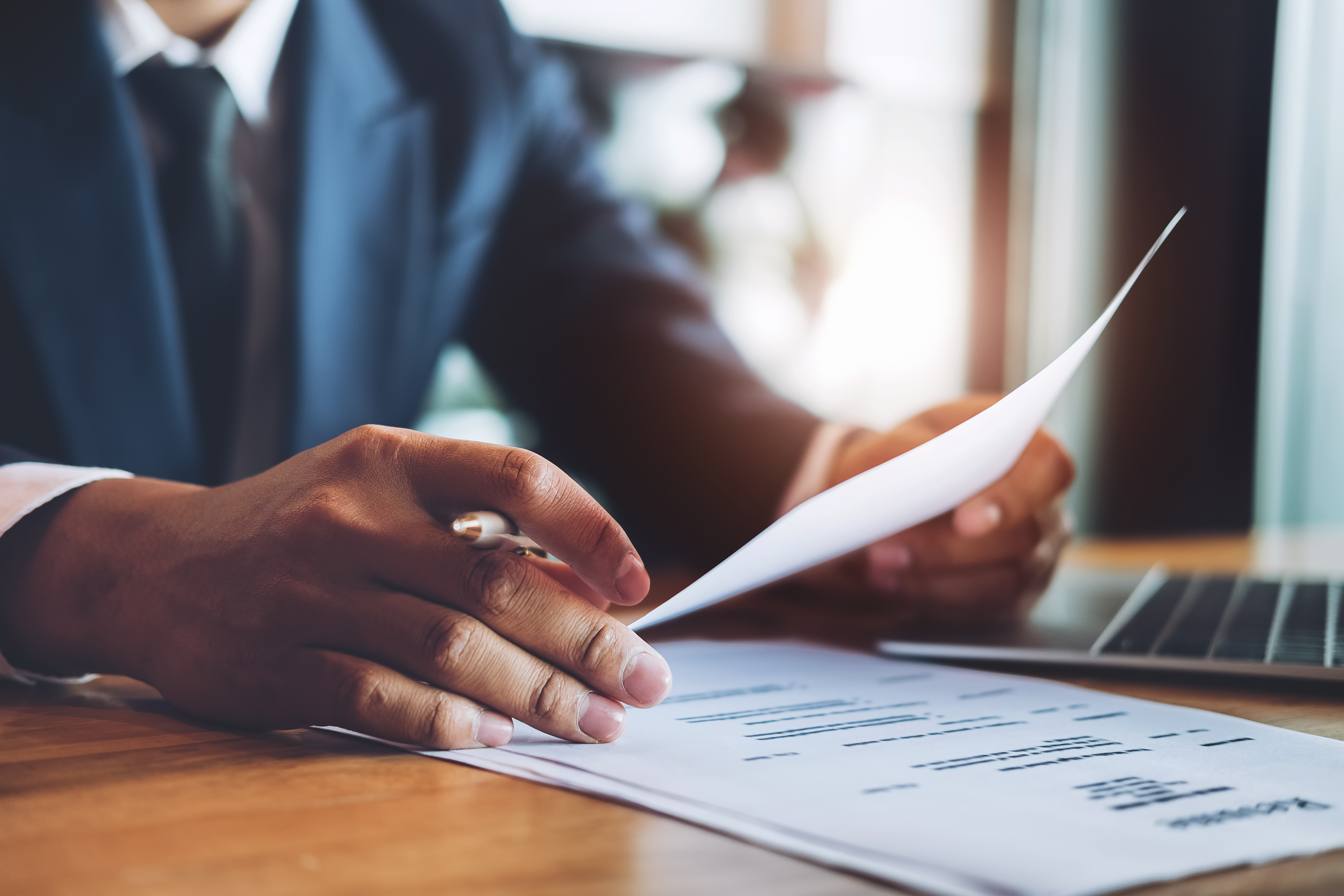 A man holds a resume in his hands.
