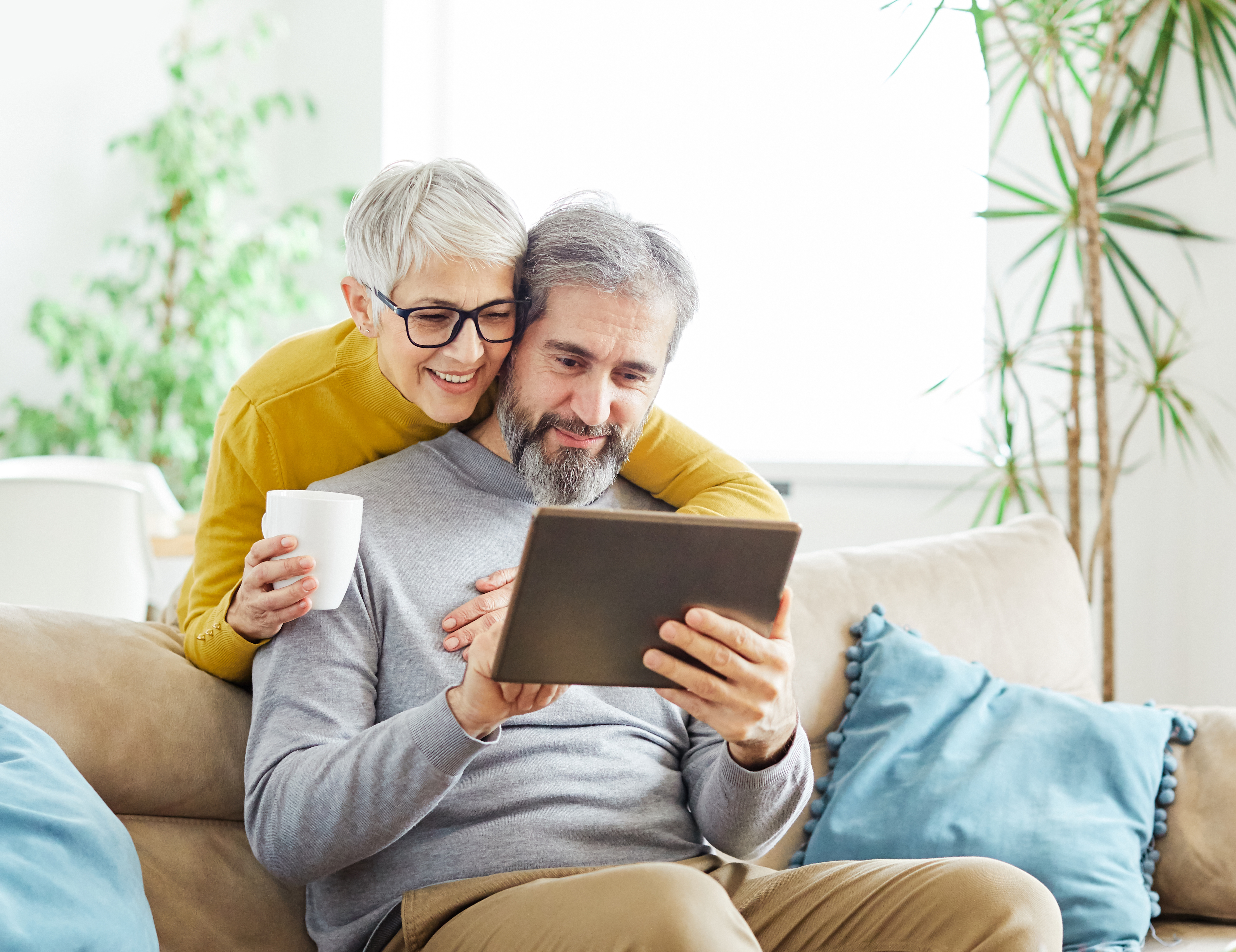 A senior couple looks at a tablet together.