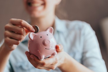 Putting money in piggybank