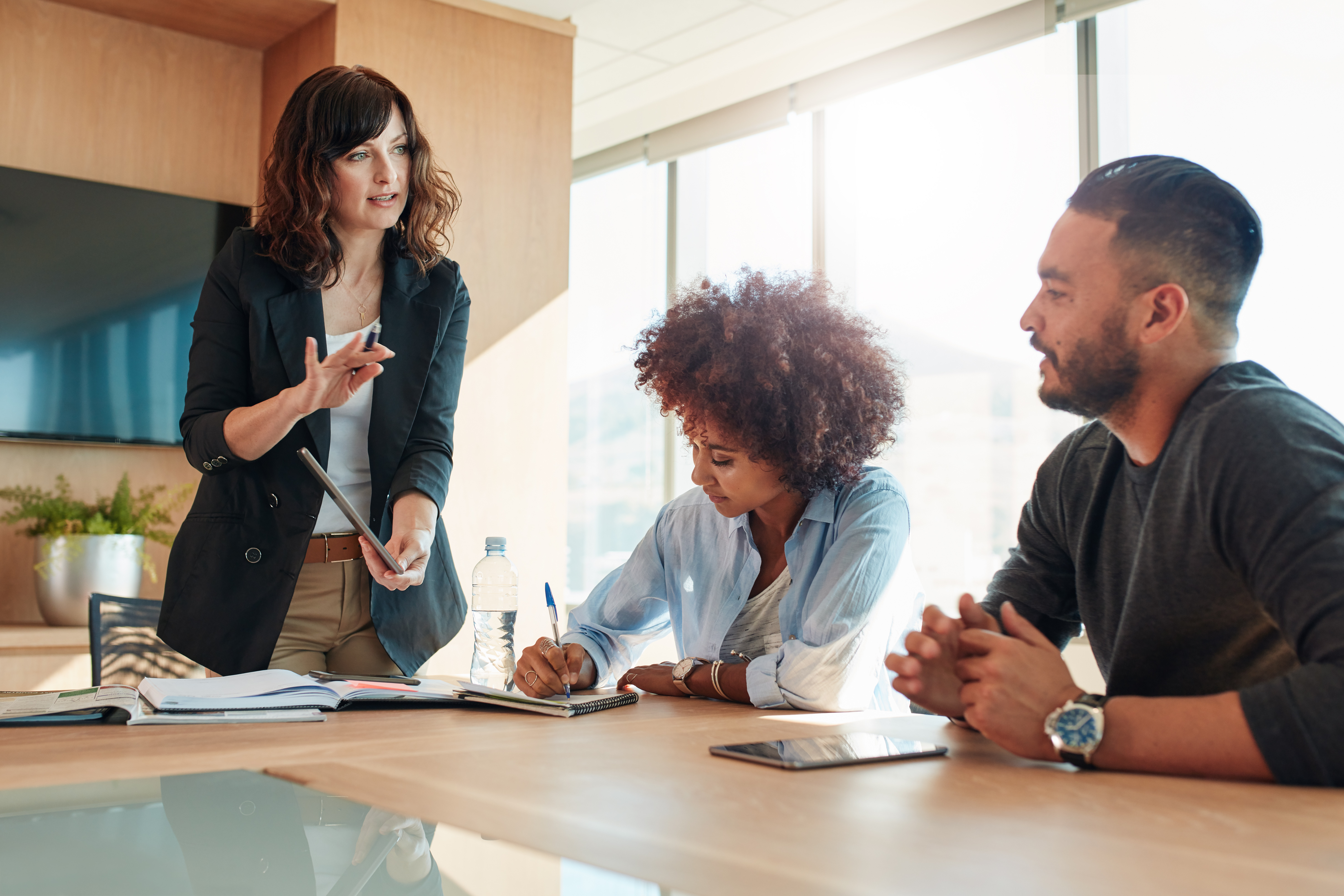 Manager speaking with employees in office