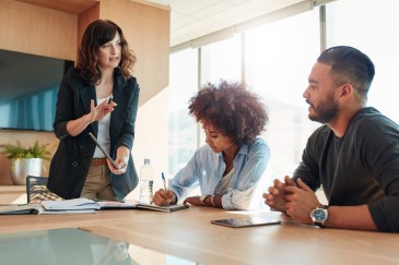 Manager speaking with employees in office