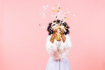 Woman throwing confetti in the air