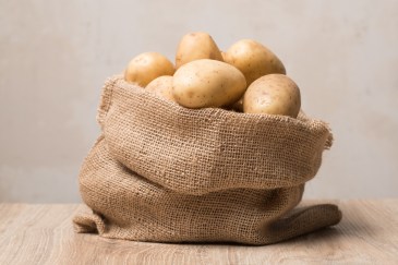 A burlap sack filled with potatoes