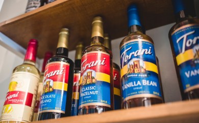 Torani syrups on the shelf of a coffeehouse.