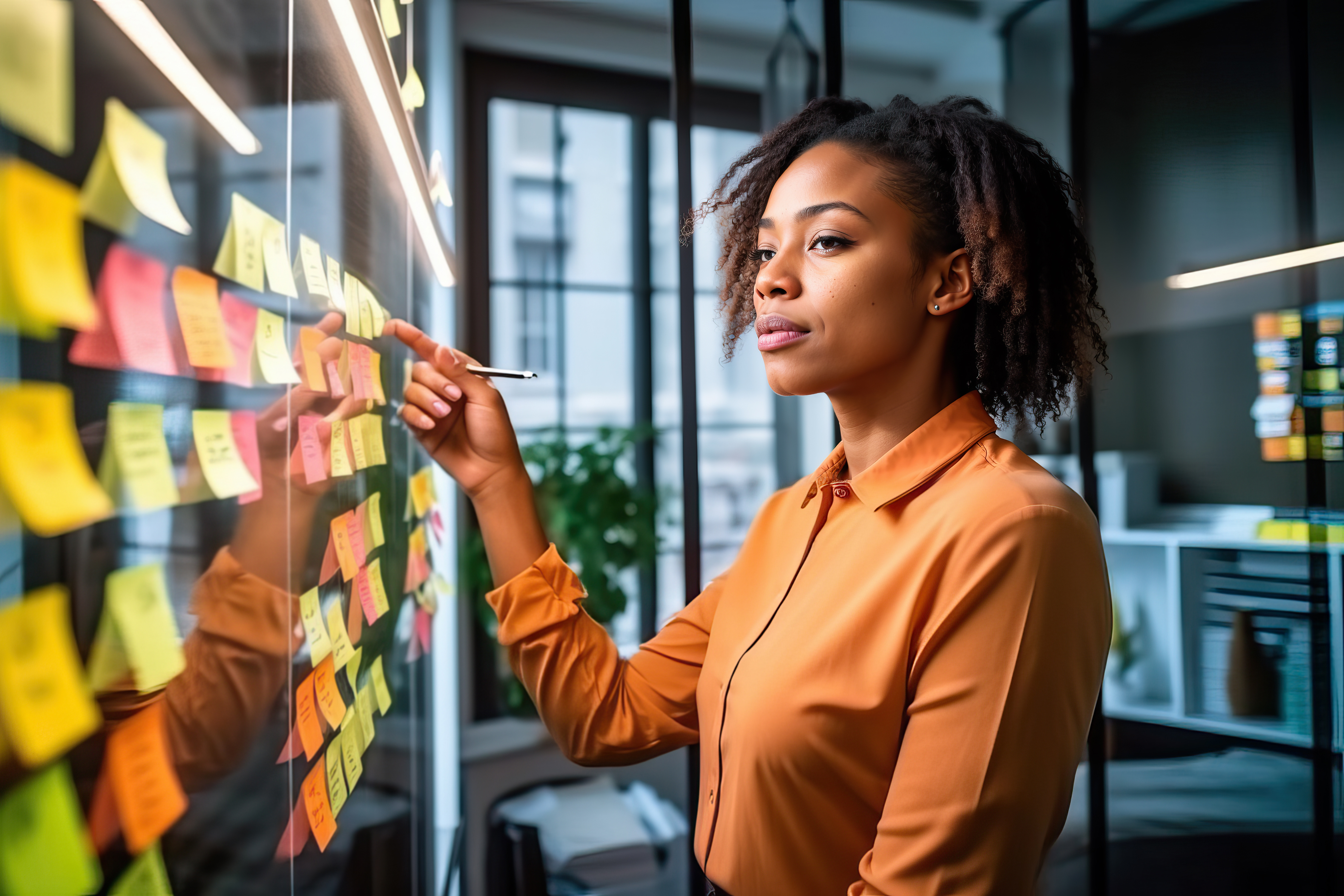 Woman standing in front of a wall with post-it notes