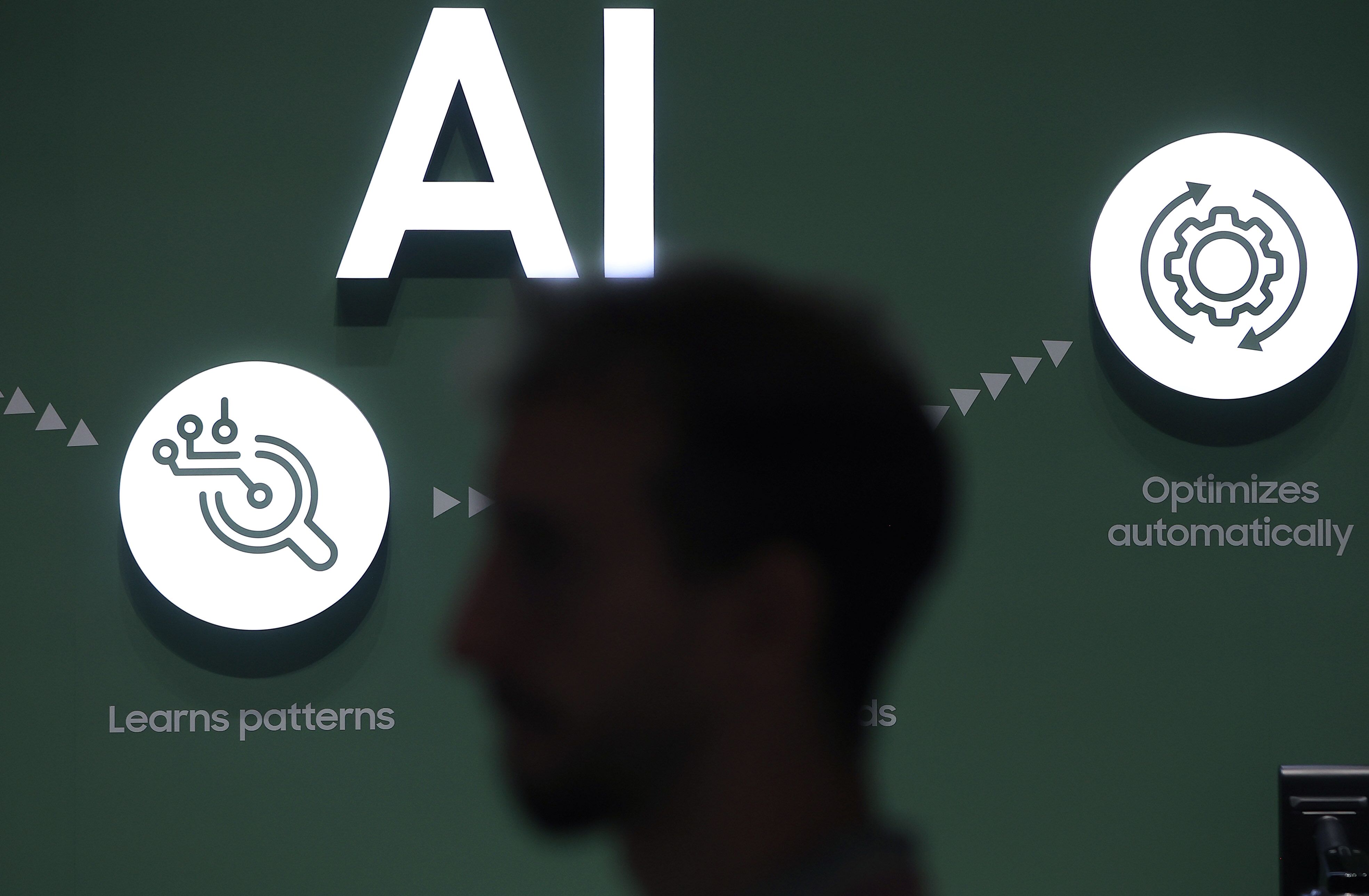 AI sign with a worker walking past