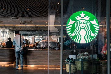 The entrance of Starbucks, with the cash register in the background.