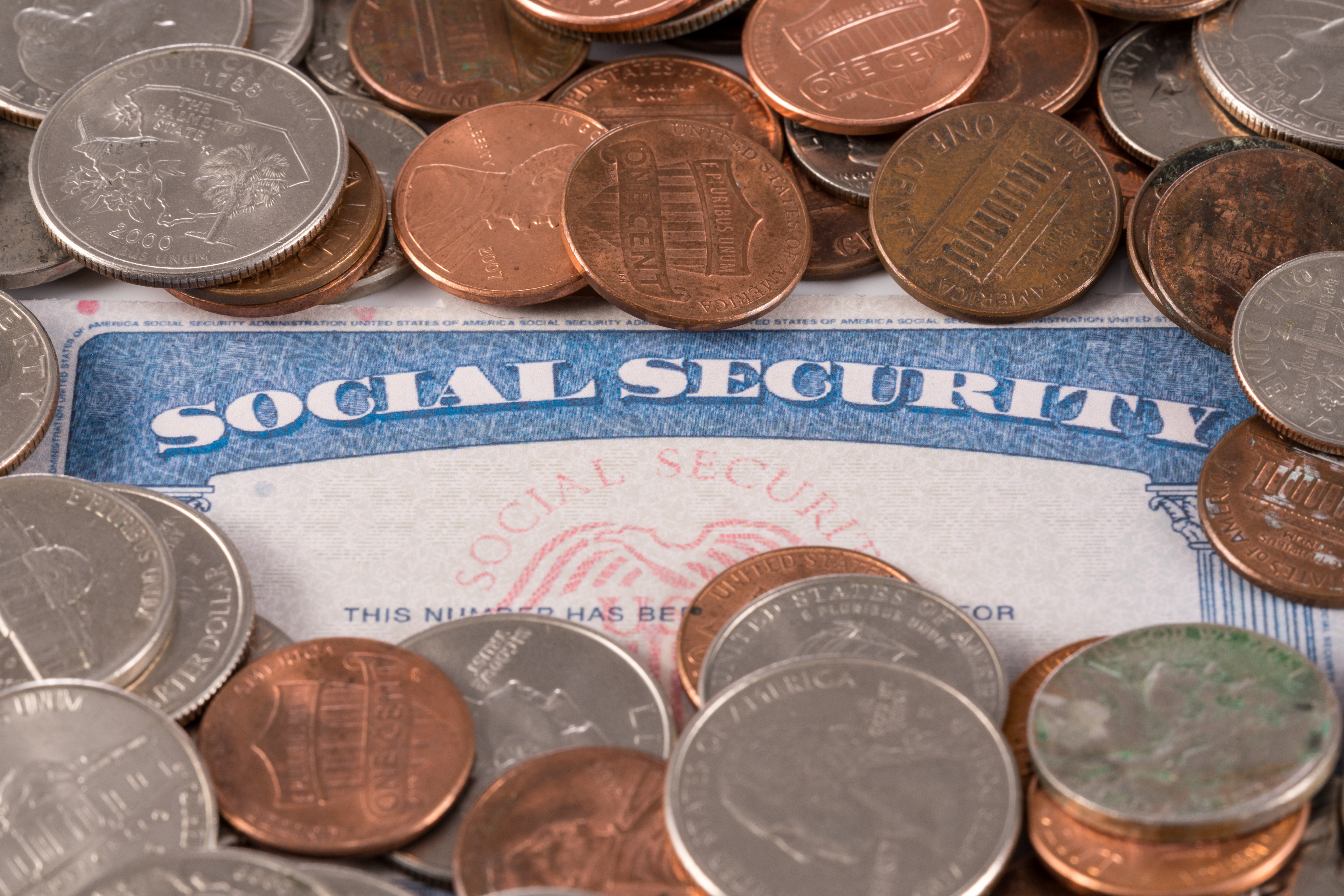 Social Security card surrounded by coins