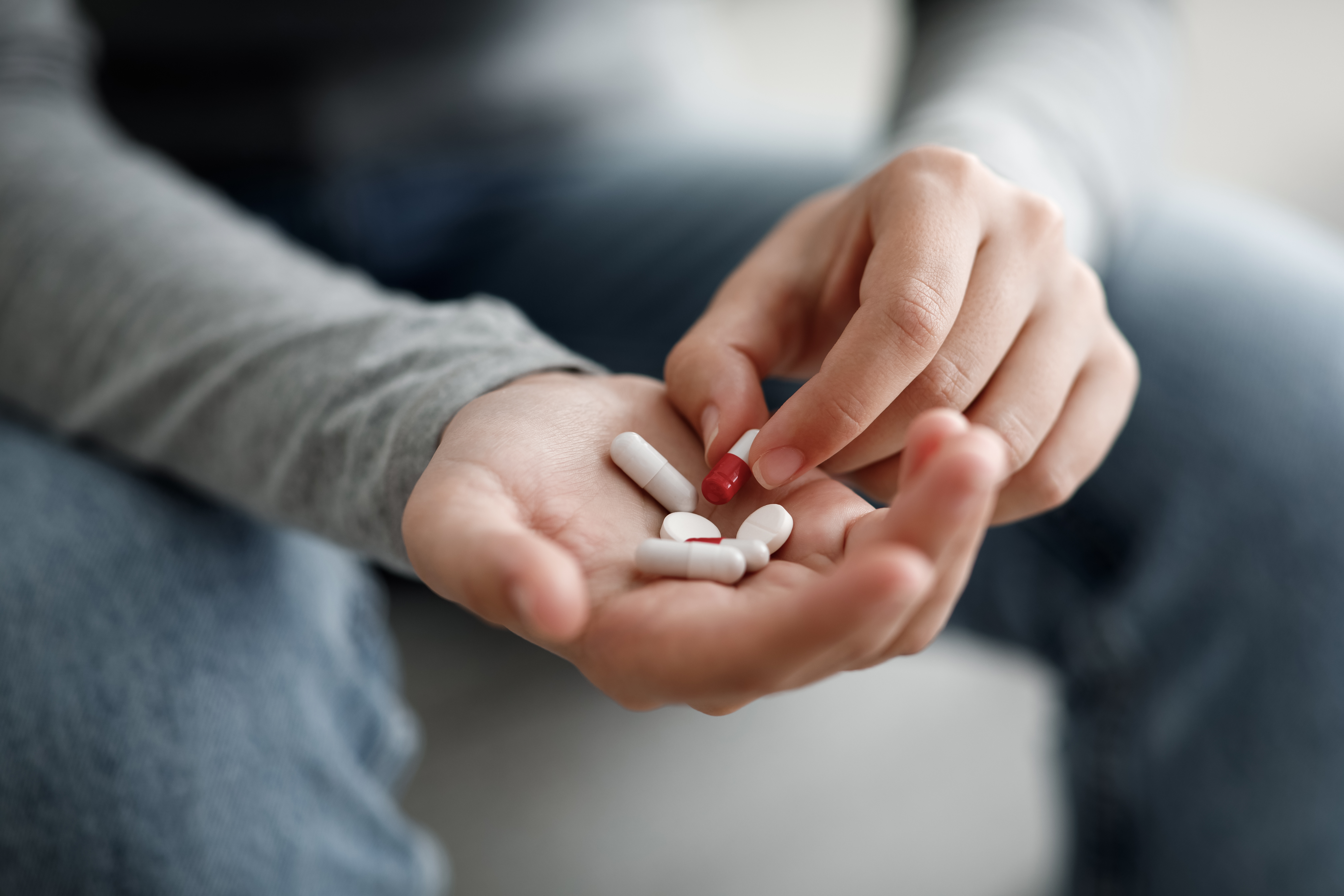 Person holding pills in hand