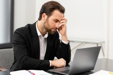 Employee with head in hand