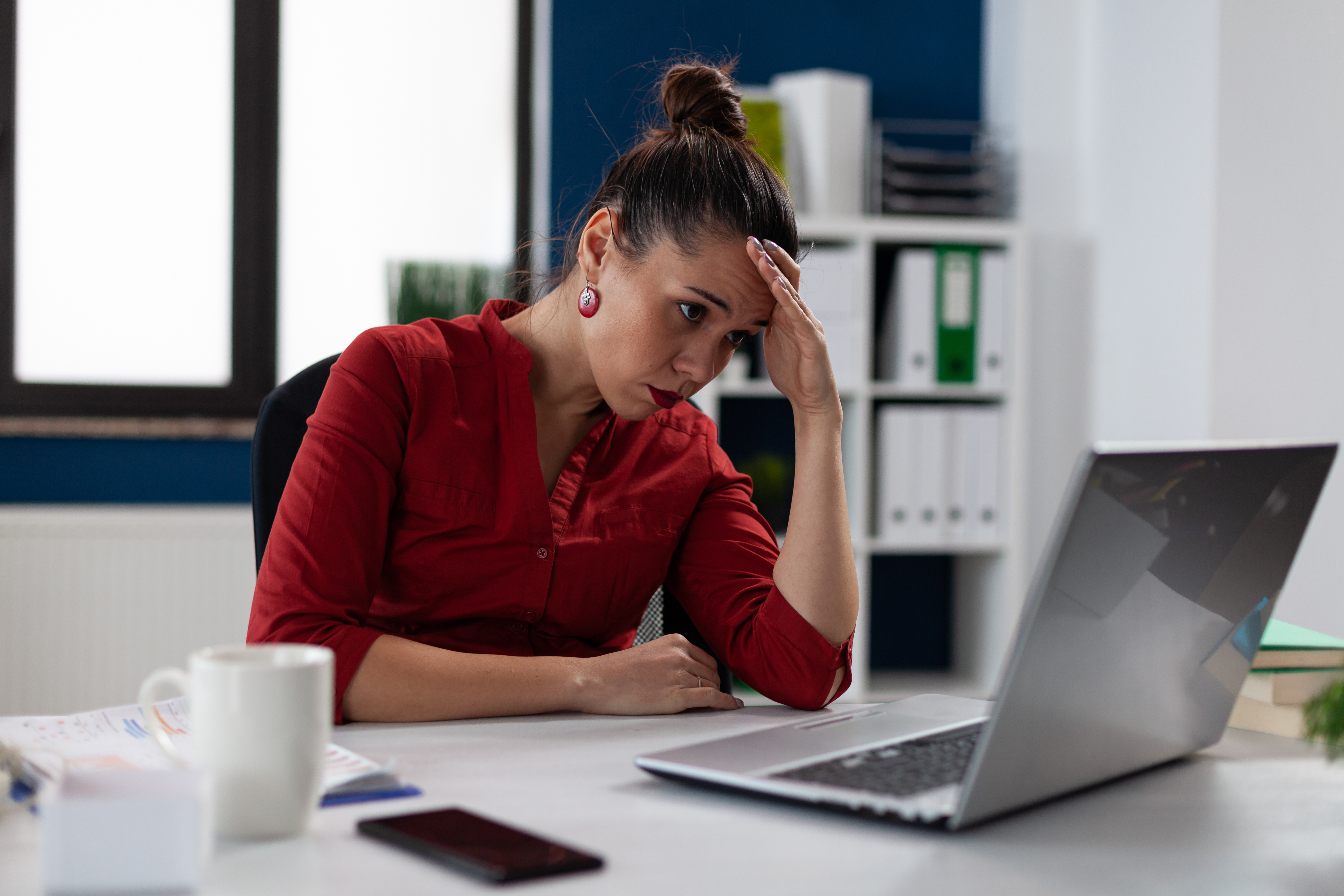 Woman looking upset staring at her computer