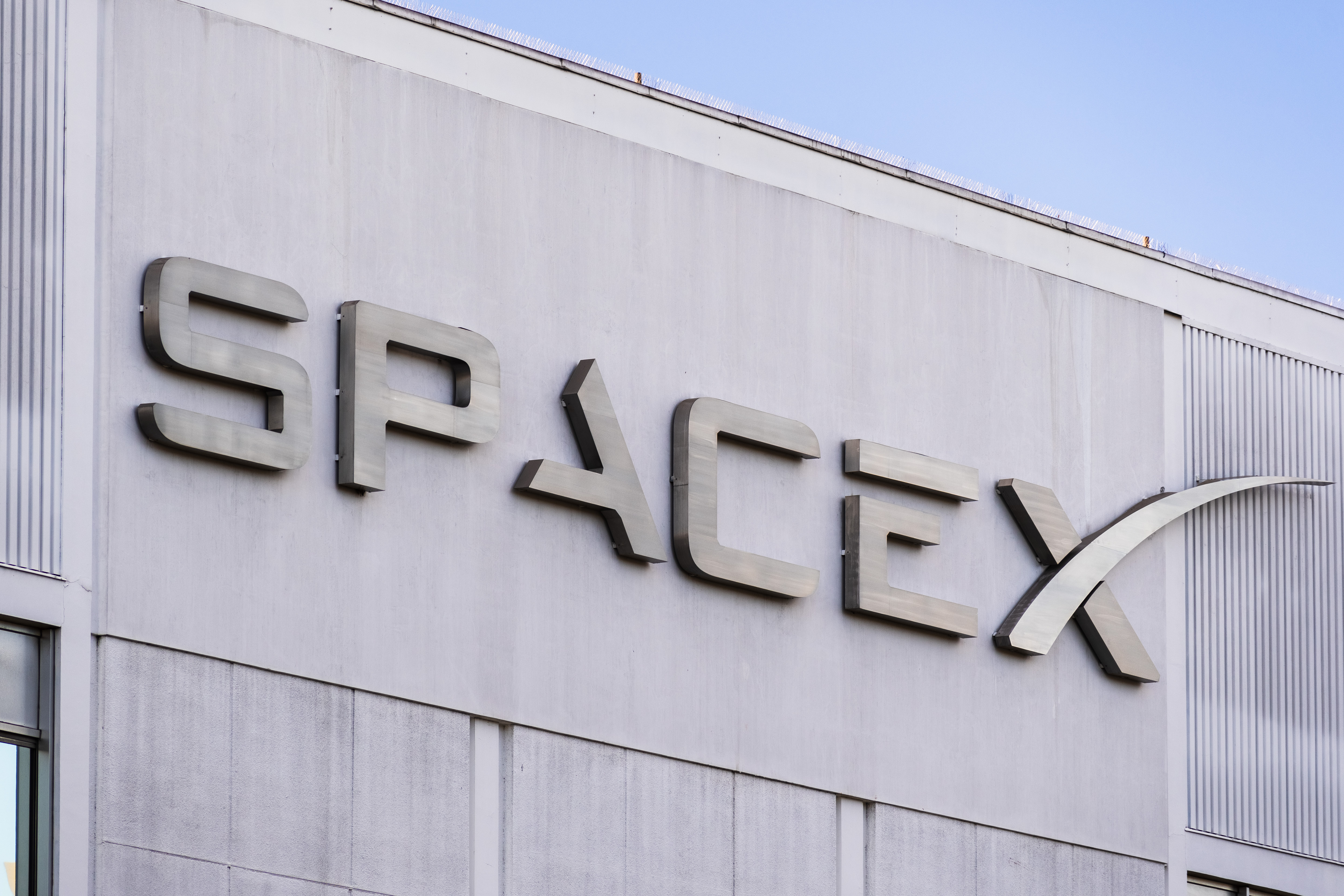 SpaceX logo on a gray building.