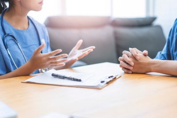 Doctor talking through fertility options with a couple.