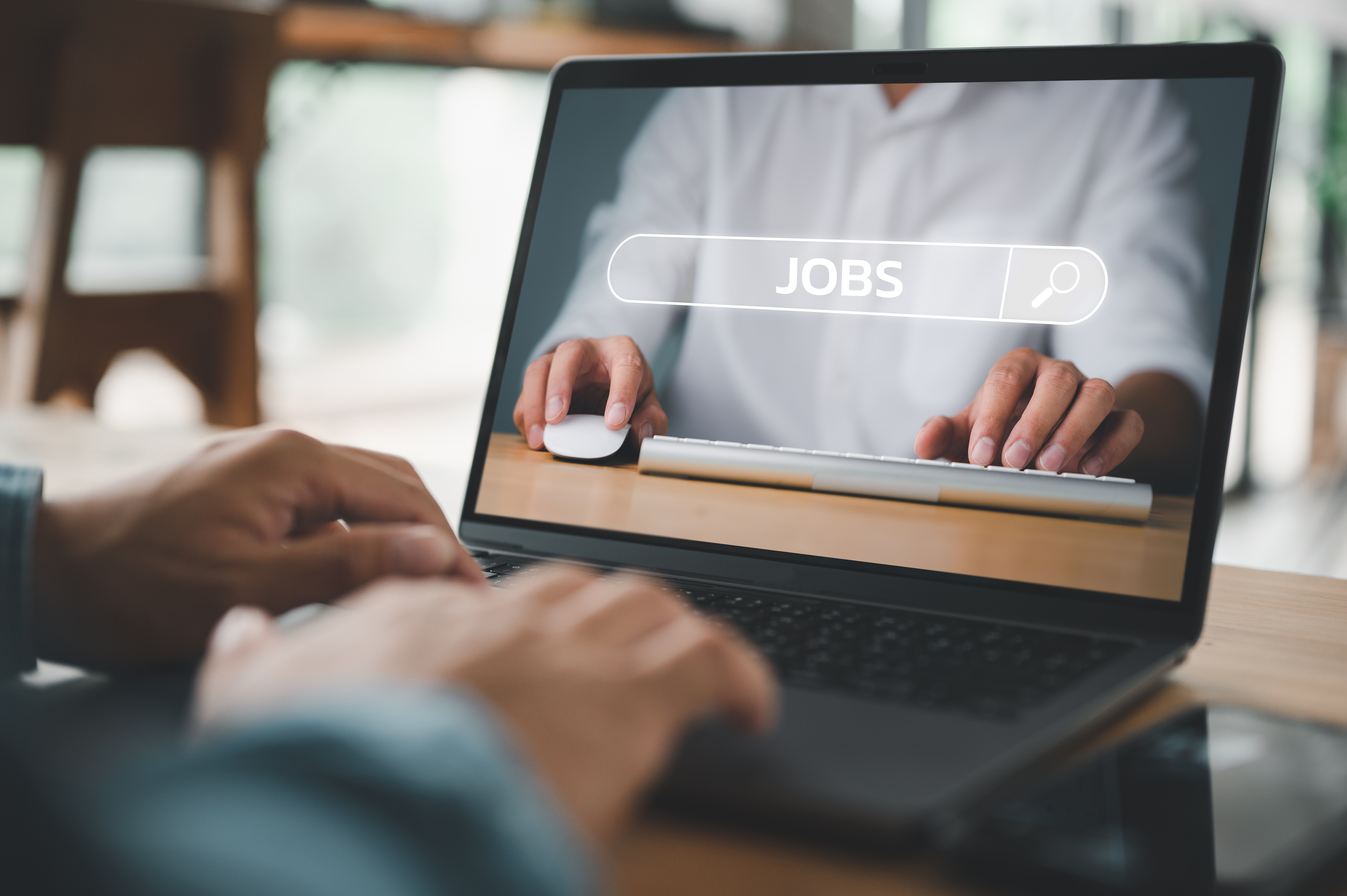 Man searching for job on laptop