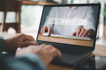 Man searching for job on laptop