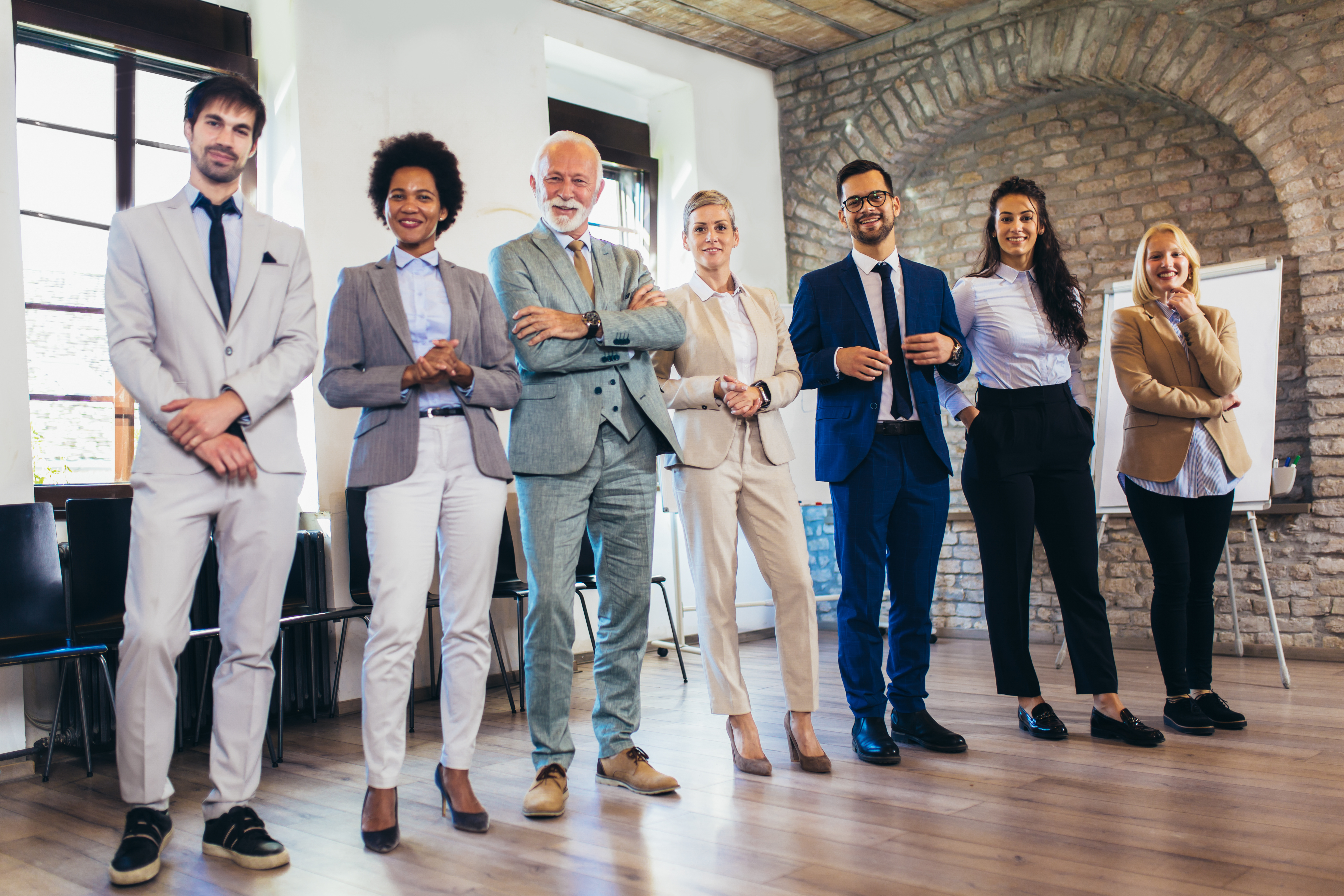 Group of employees standing in angled line in office