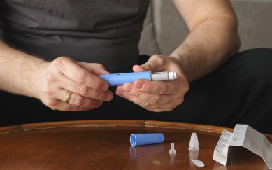 Man holding a package of the weightless drug Ozempic