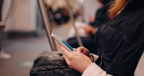 Young woman scrolling social media on the phone.