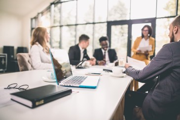 A group of employees working together in a conference room