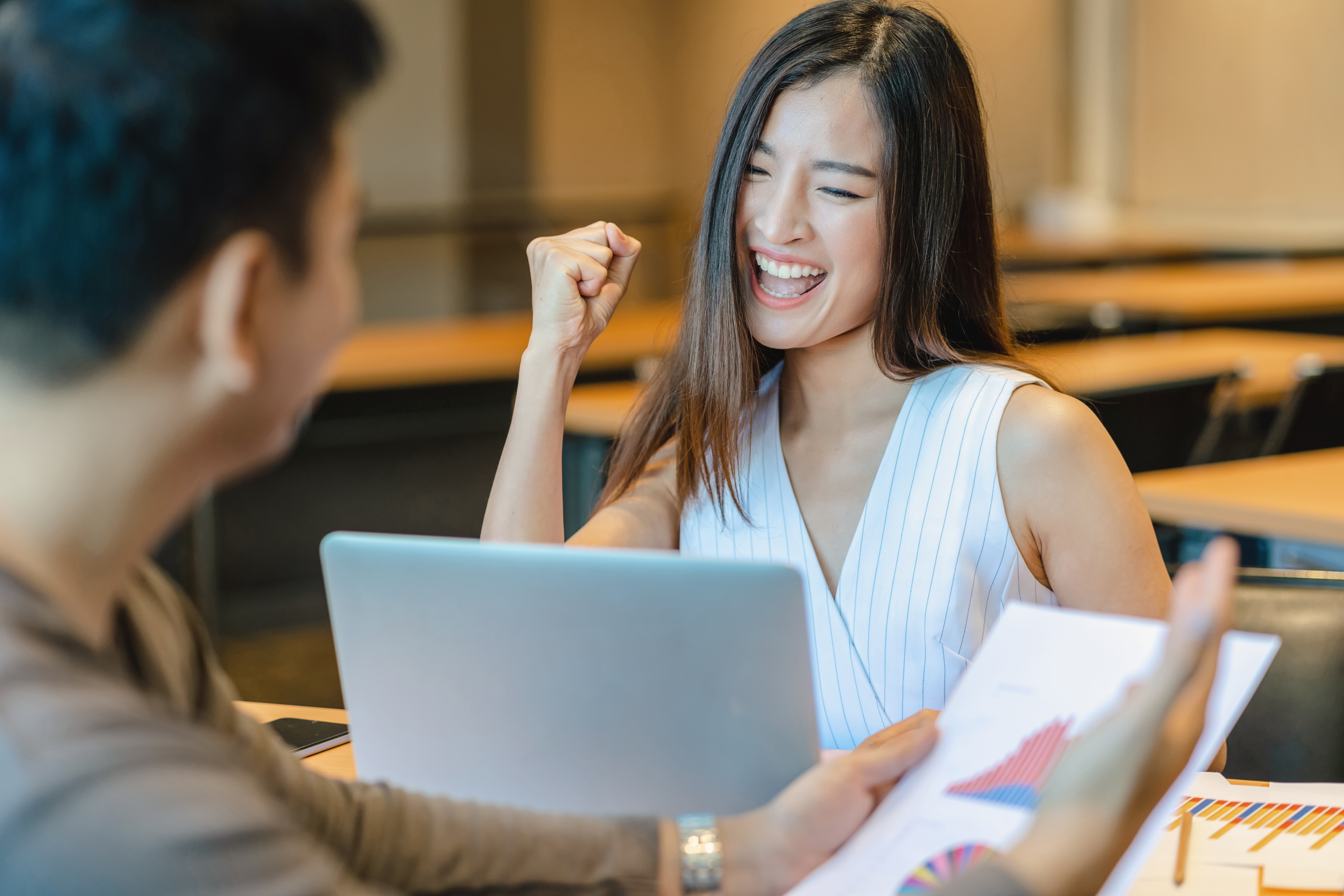 Asian woman celebrating at work