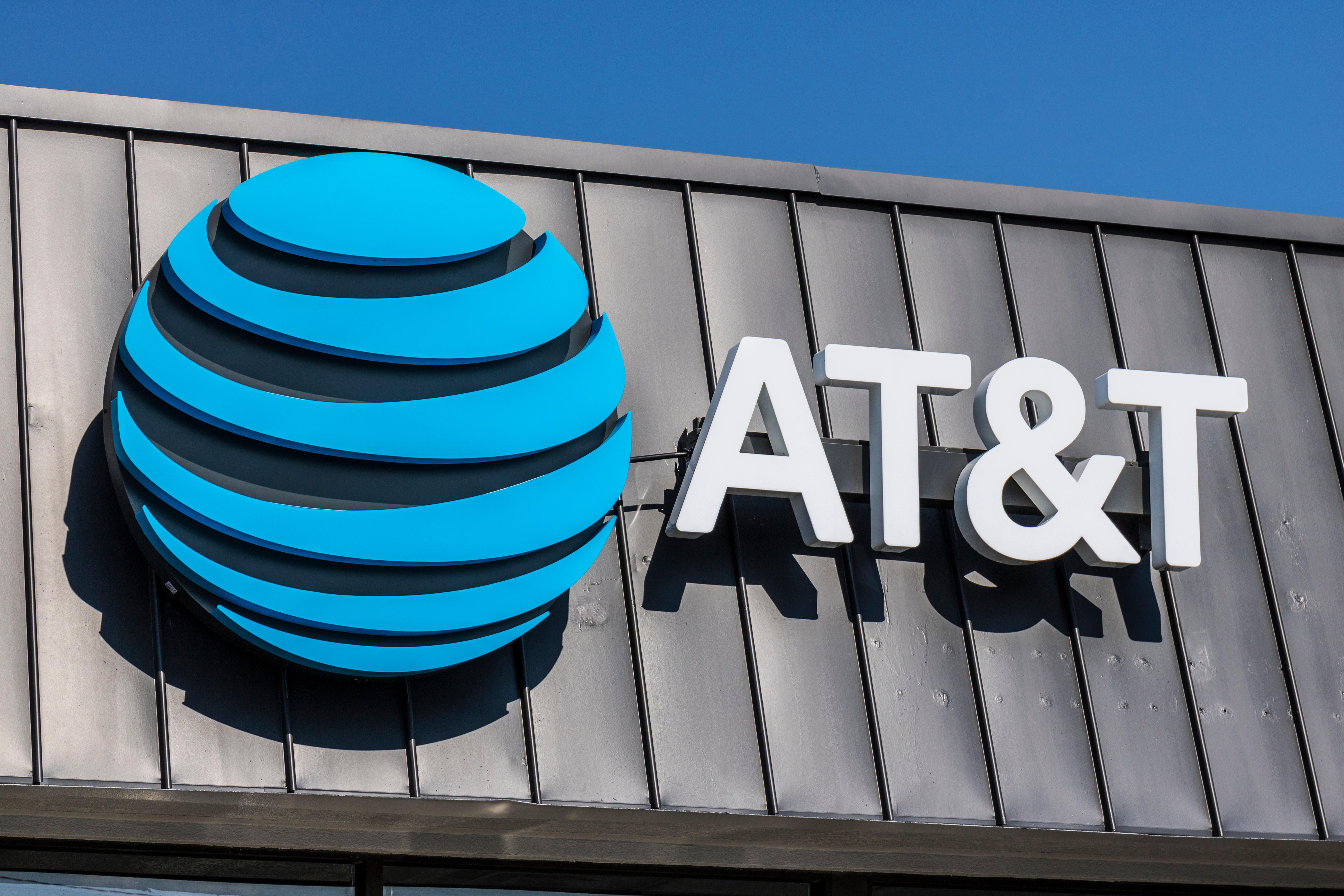 AT&T's blue circular logo on a gray building.