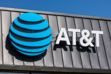 AT&T's blue circular logo on a gray building.