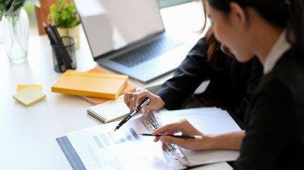 Women going over financial document together.