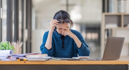Woman stressed at her desk.