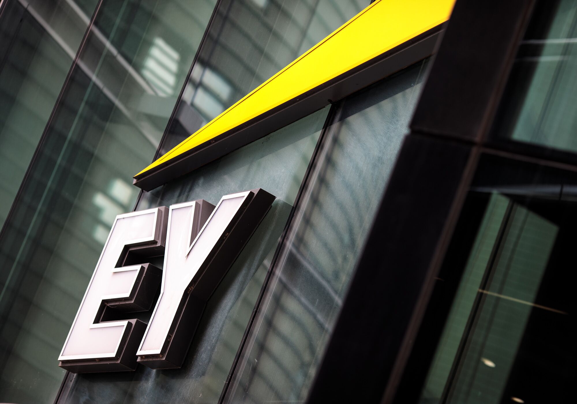 EY logo outside of an office building
