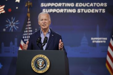 President Biden standing at a podium giving a speech