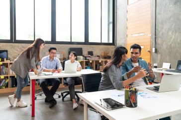 Employees having different conversations in the office.