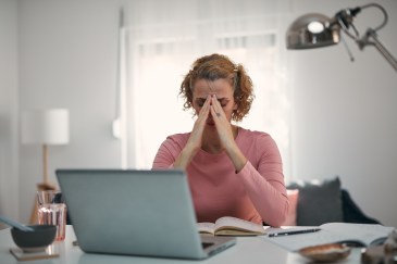 Woman looking upset while sitting in front of her computer