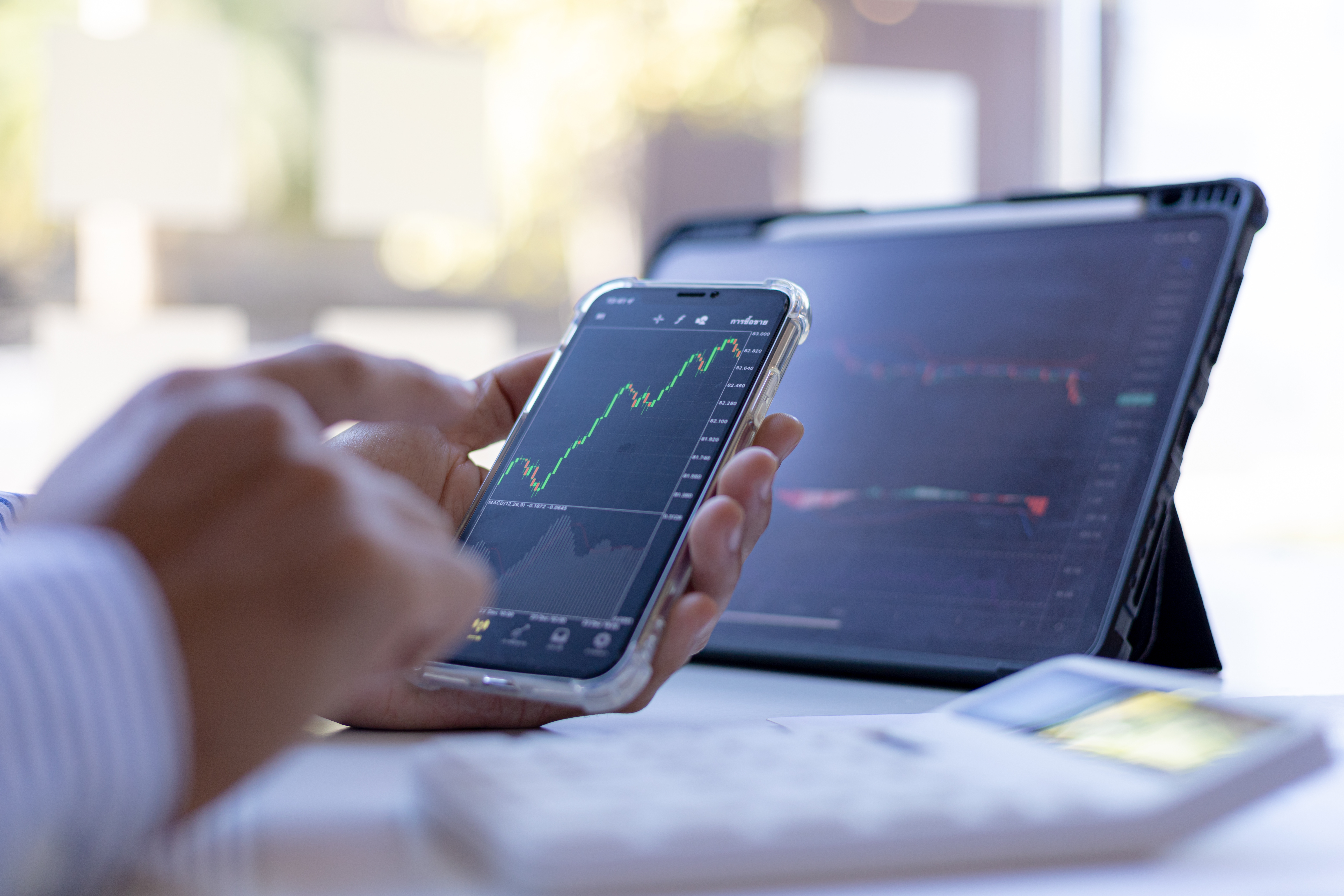 Man looking at a stock chart on his phone