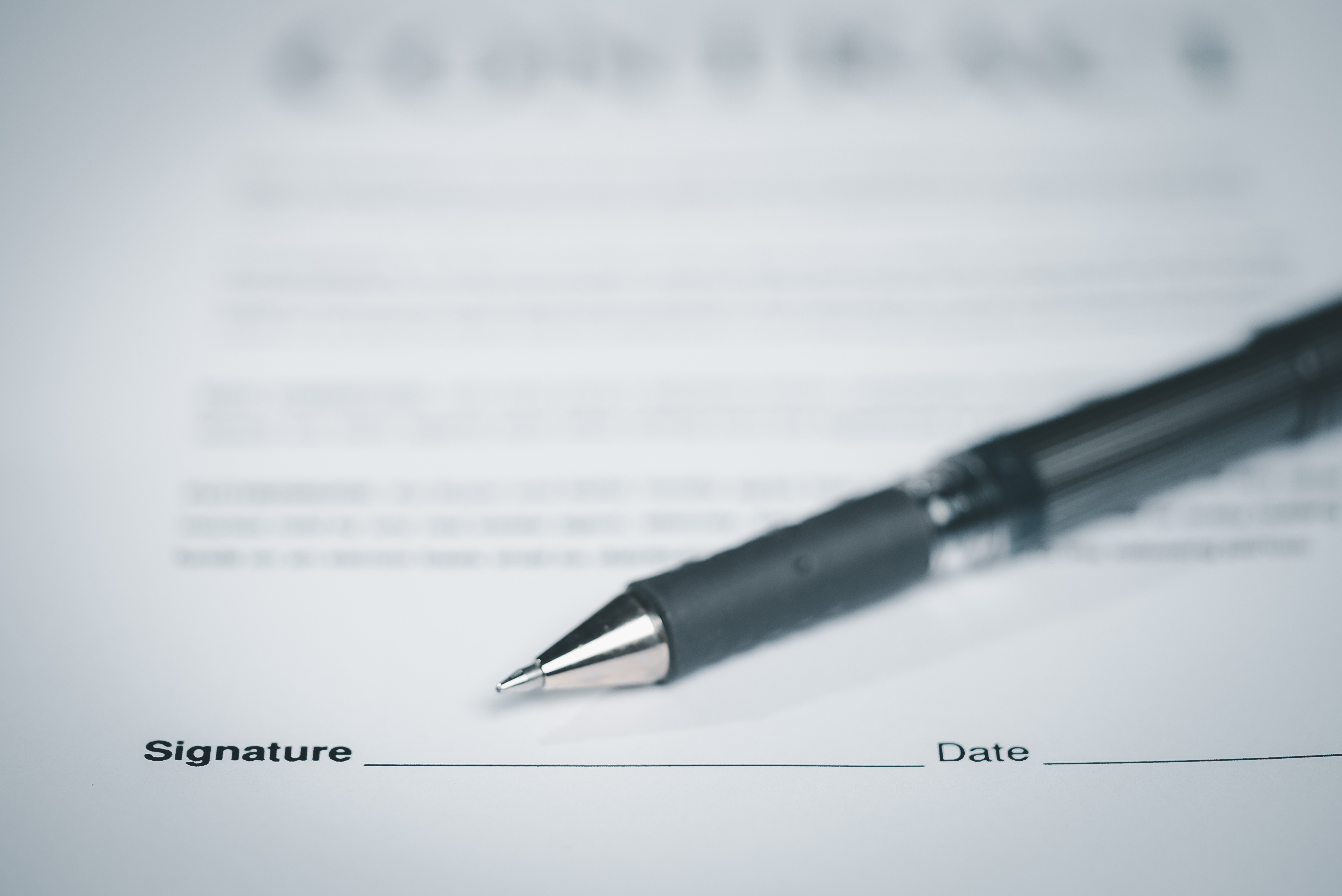 Blank signature line on contract with pen