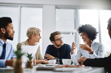 Group of employees at table talking
